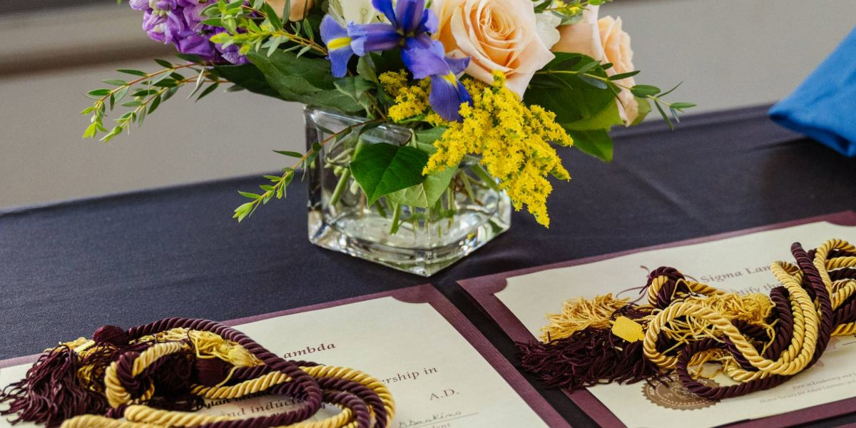 table with certificates and vase of flowers