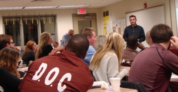 Students and inmates sitting in a classroom during a Pitt Prison Education Project lecture.