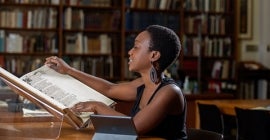 student reading a book in library