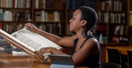 Student reading a book in library