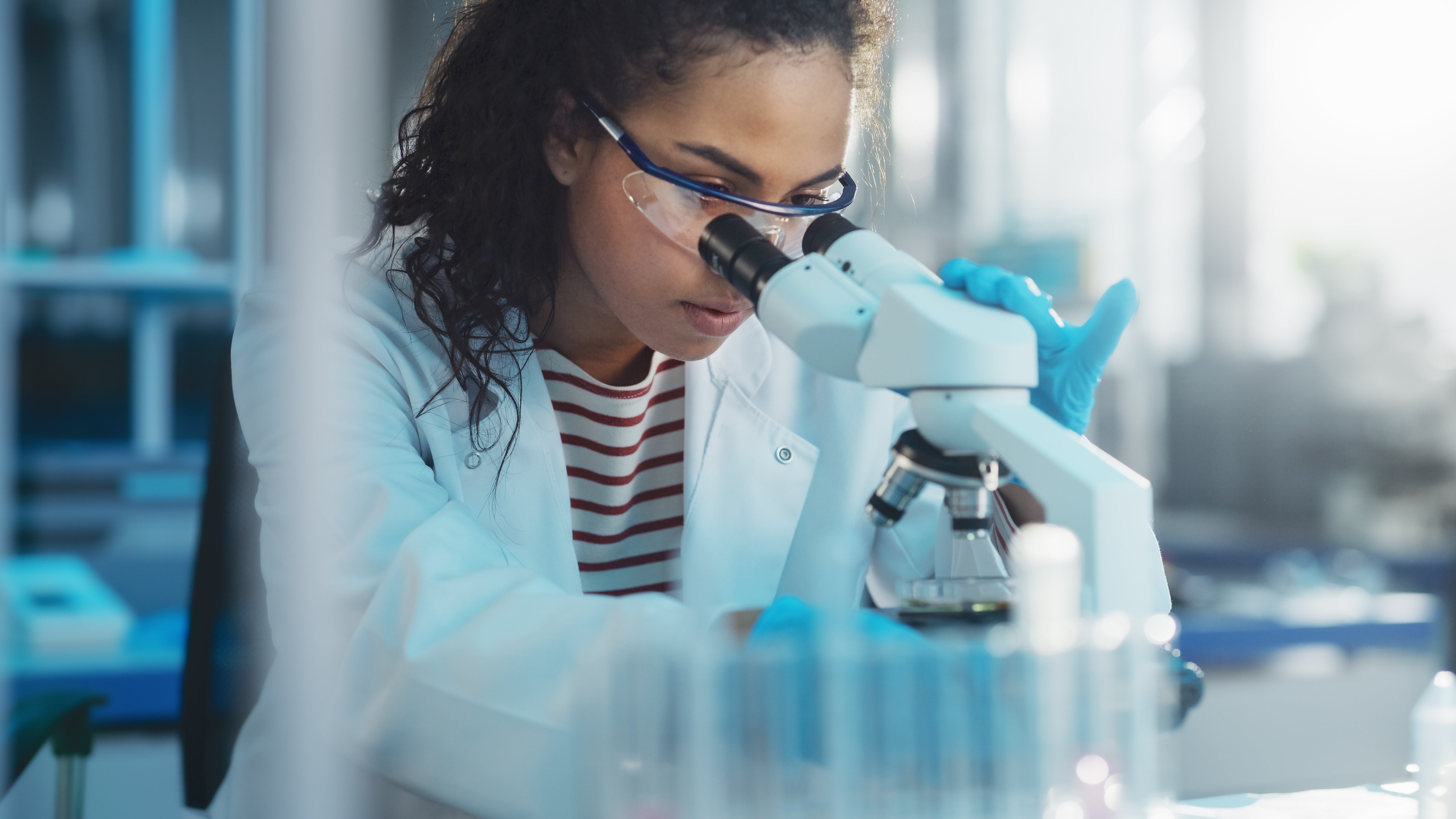 High school student using a microscope