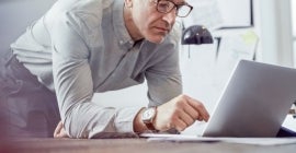 Instructor typing on a laptop