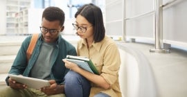 Two students looking at laptop