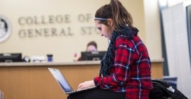 girl with plaid shirt in CGS lobby