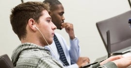 two people using laptops