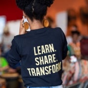 Student wearing a t-shit that reads: learn, share, transform
