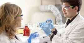 scientists wearing safety equipment in lab