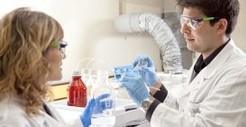 scientists wearing safety equipment in lab